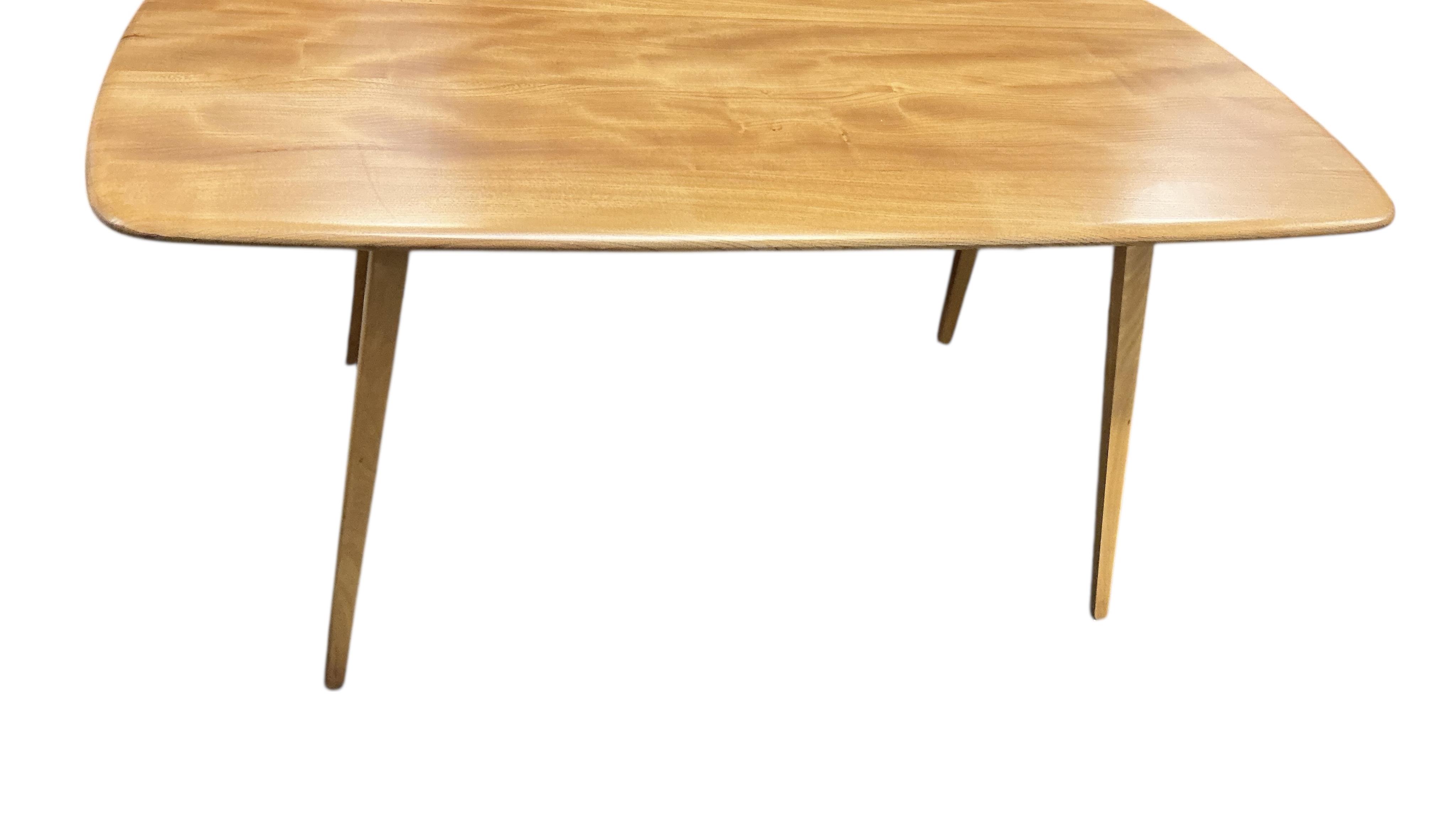An Ercol elm and beech rectangular dining table, width 150cm, 75cm, height 72cm, together with a set of six Ercol elm and beech comb back dining chairs, two with arms and an Ercol style sideboard